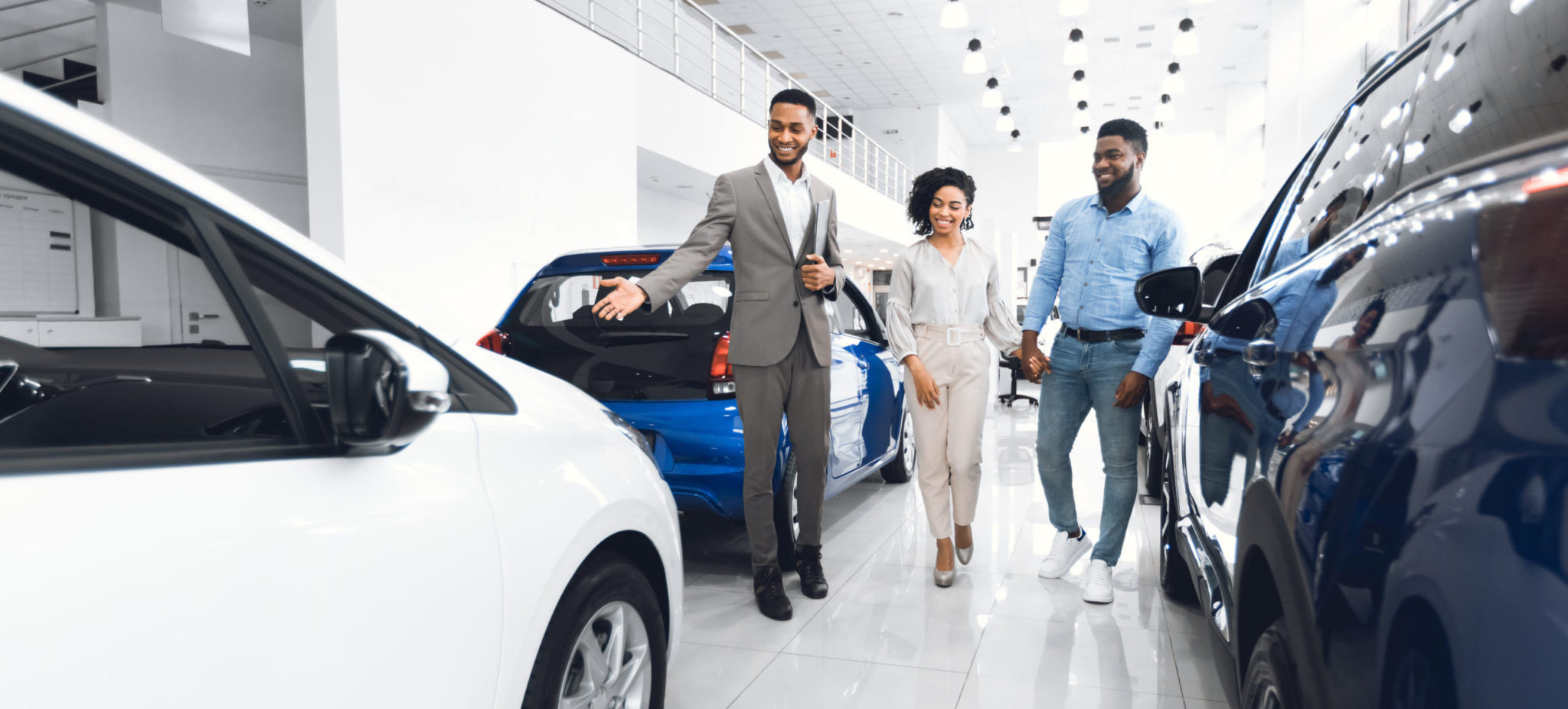 Car Selling Business Manager Showing Luxury Automobile To Man And Spouse